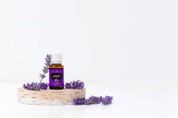 Lavender essential oil next to dried lavender.