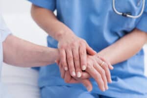 Doctor holding a patient's hand.