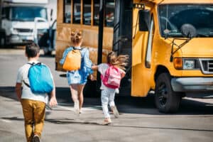 Kids running to the school bus.