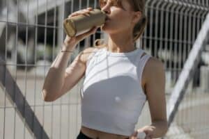 Woman drinking water after a workout.