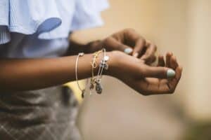 Woman with a variety of bracelets on her wrist.