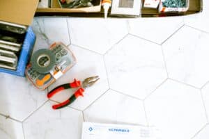 Bathroom renovation tools on tiles.