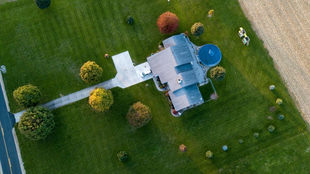 View of a large house and lawn from above.