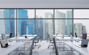 Workplaces in a modern panoramic office, Singapore city view from the windows. Open space. White tables and black leather chairs. A concept of financial consulting services. 3D rendering.