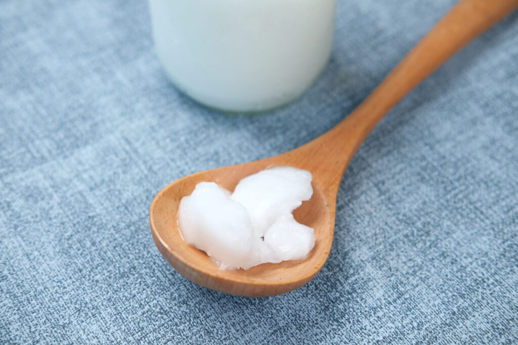 spoon with coconut oil on table