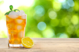 Glass of tea on a picnic table.
