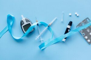 Diabetes supplies on a blue background.