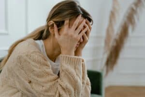 Woman holding her head in pain or grief.