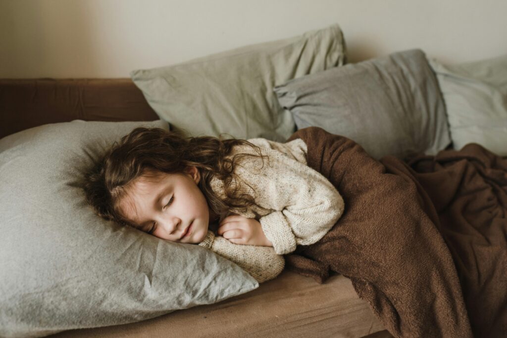 Toddler girl sleeping in her bed.
